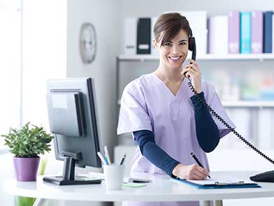 Woman answering the phone at a dental office