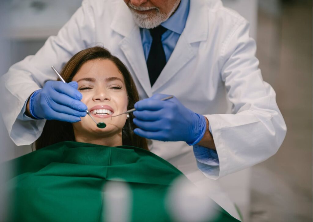 Patient receiving a dental examination while discussing how Ozempic may affect oral health, including changes in saliva production and tooth health.