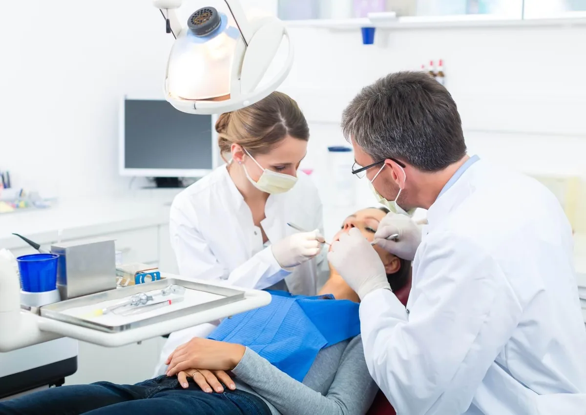 Dental team performing treatment on a patient receiving full mouth dental implants.