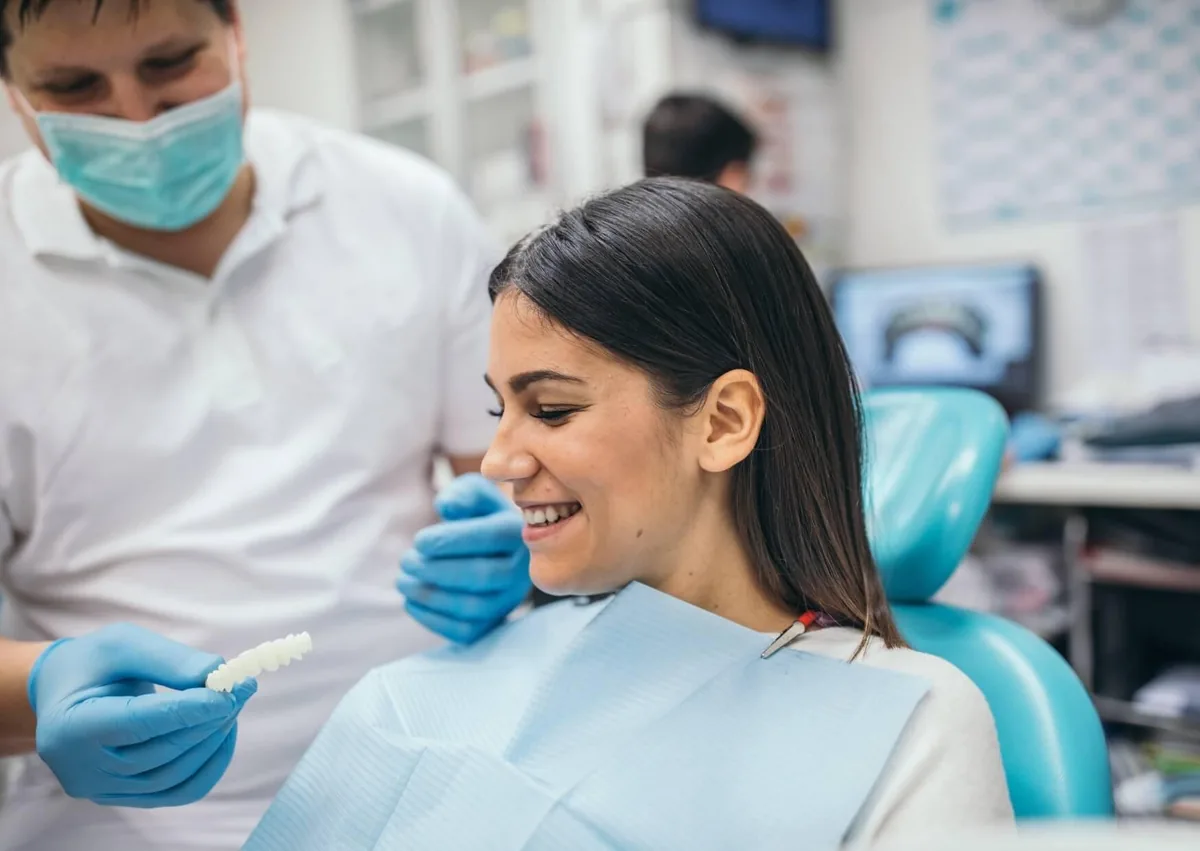 Dentist discussing cosmetic treatment options with a patient planning a smile makeover.