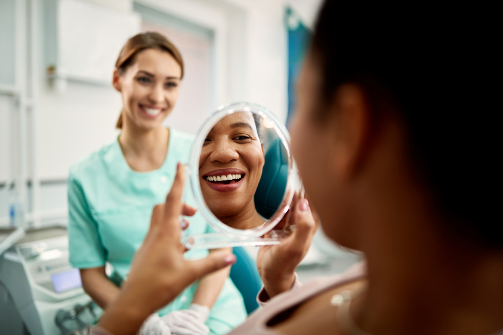 person smiling in a mirror Botox Buford Dentist NACCID (770) 932-1115