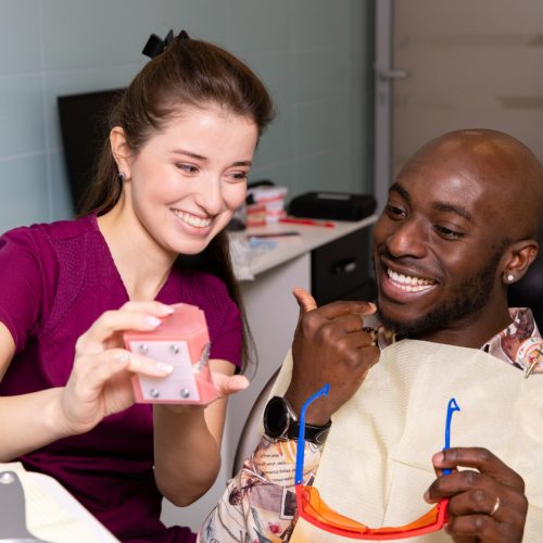 A man smiles as he consults with his dental professional - naccid, burford, GA