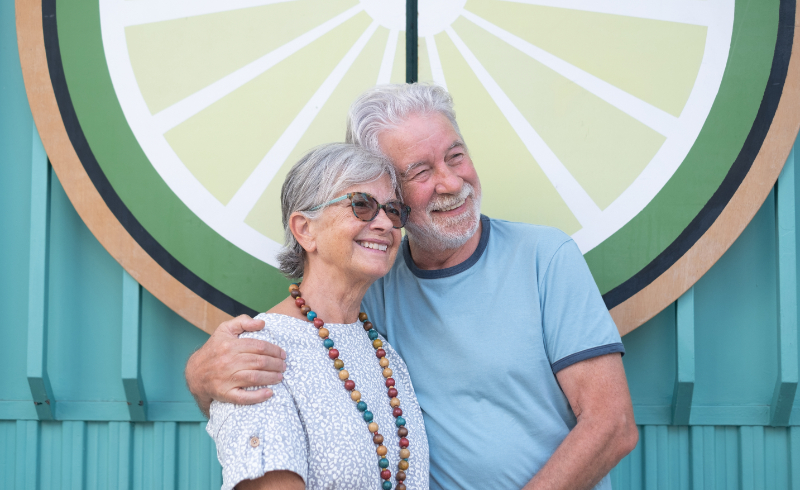 older couple with youthful smiles thanks to cosmetic dentistry