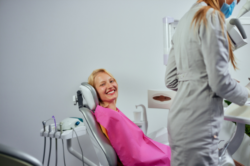 Display an image of a person smiling brightly, showcasing the success of dental implant treatment.