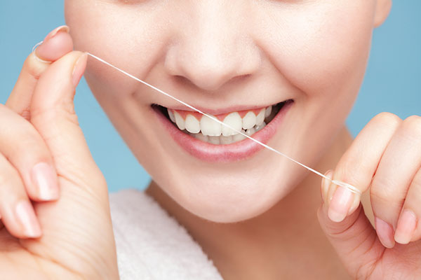 Smiling Person Flossing